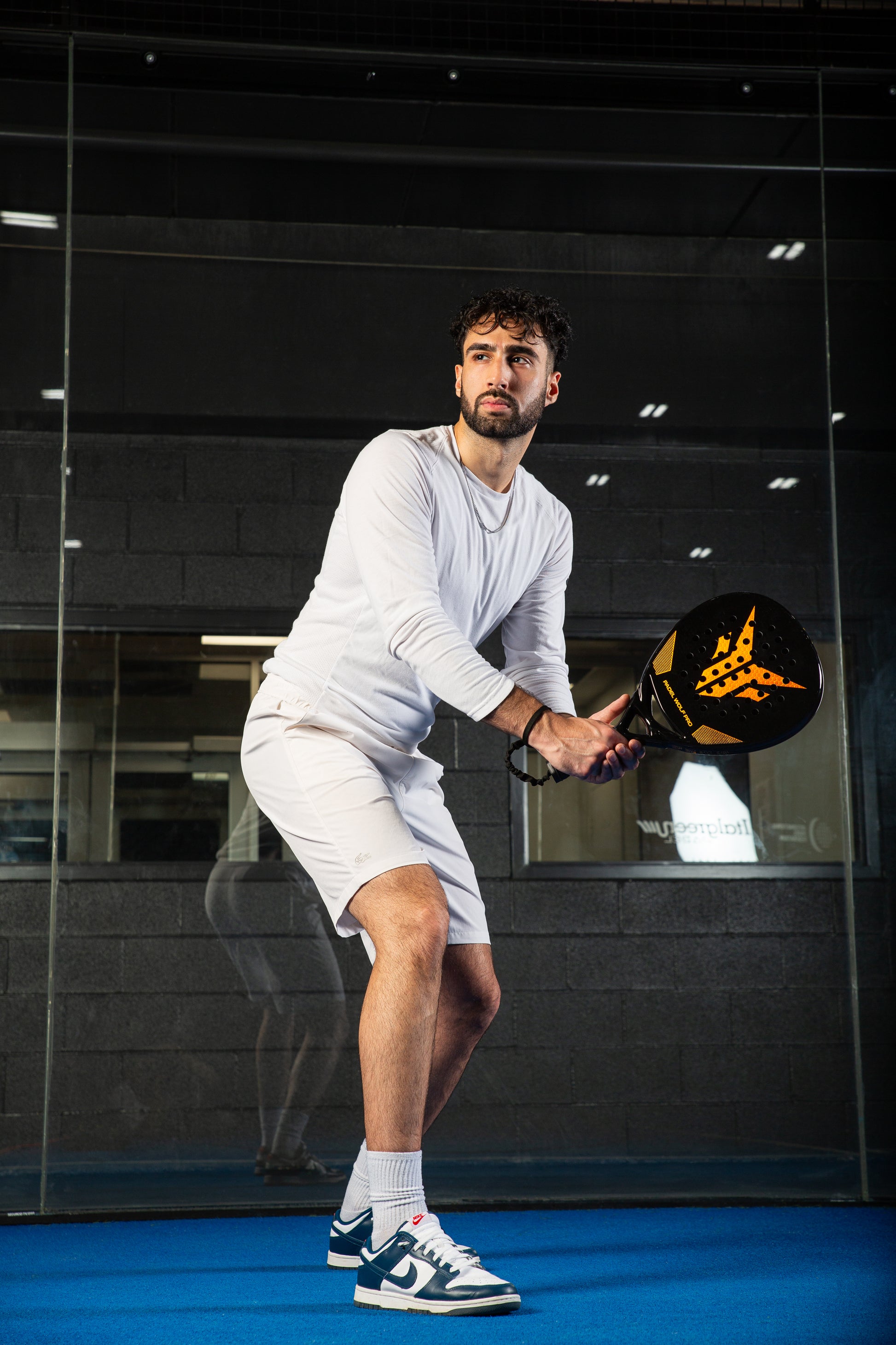 A Canadian Model posing with a padel racket from Padel Wolf Pro, a Canadian Padel Racket Company